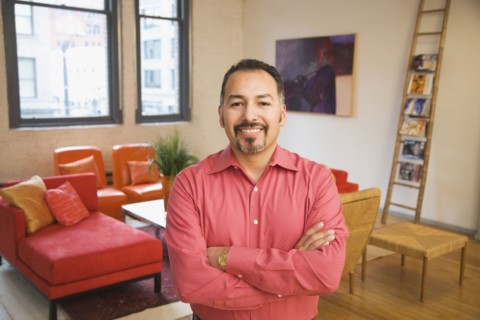 Hispanic man with arms crossed