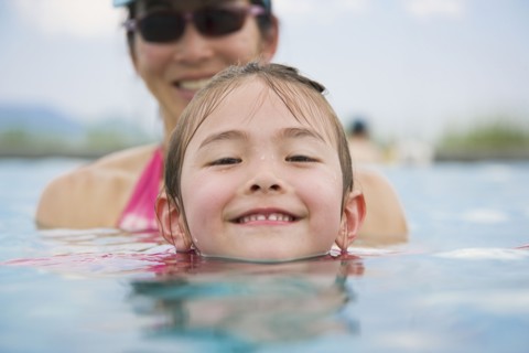 Asian girl and mother in swimming pool