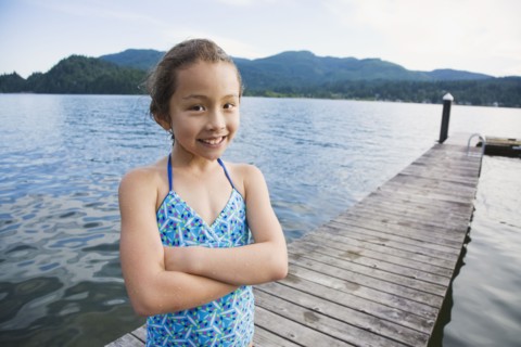 Asian girl standing on dock