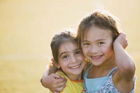 Smiling friends hugging