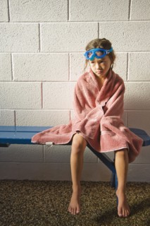 Sad Asian girl in towel and goggles