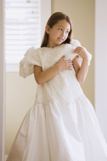 Asian girl trying on wedding dress
