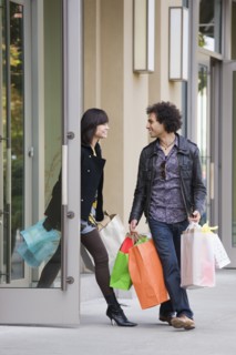 Couple leaving store with shopping bags