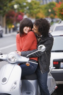 Couple sitting on scooter