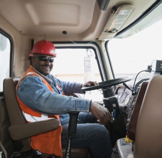 African construction worker driving truck