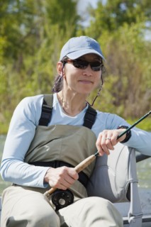 Japanese American woman holding fly fishing pole
