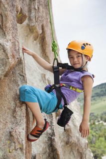 Mixed race girl rock climbing