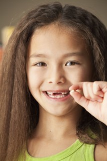 Mixed race girl holding toothy