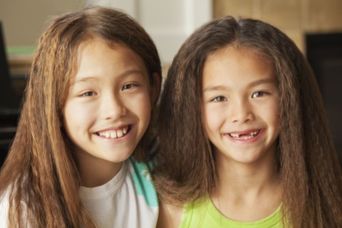 Mixed race sisters smiling
