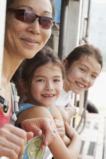 Mother and daughters riding on boat