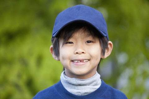 Smiling Korean boy in baseball cap