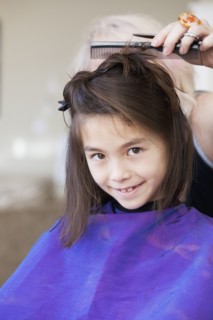 Mixed race girl getting her hair cut