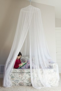 Mixed race girl reading on sofa