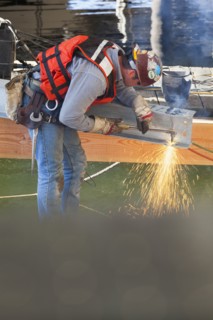 Caucasian worker welding on construction site