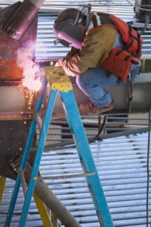 Construction worker welding metal