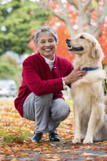 Mixed race woman petting dog