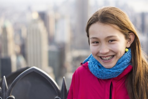 Mixed race girl smiling on urban rooftop