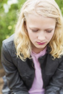 Caucasian girl sitting outdoors