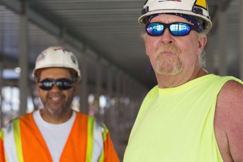 Workers smiling together at construction site