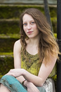 Caucasian teenage girl sitting on steps outdoors
