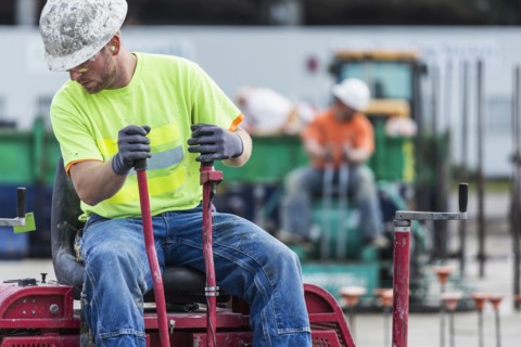 Worker operating machinery on construction site