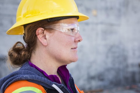 Caucasian worker wearing safety goggles on site