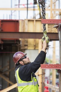 Caucasian worker holding hook at construction site