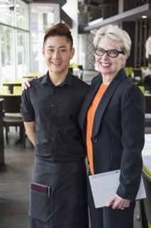 Businesswoman and water smiling in restaurant