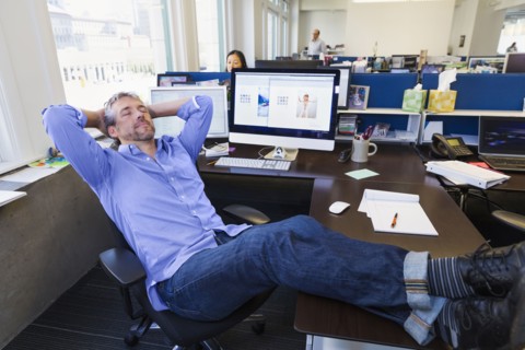 Businessman relaxing at desk in office