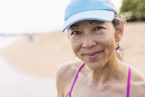 Japanese woman smiling on beach