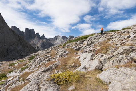 Caucasian hiker walking on rocky hillside