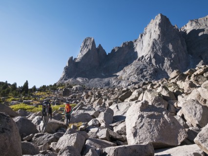 Caucasian hikers walking in rocky field