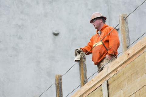 Caucasian worker standing at construction site