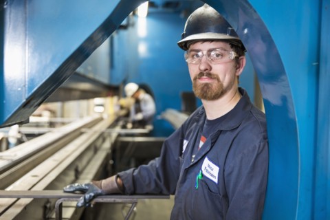 Caucasian worker posing in factory