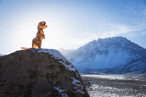 Dinosaur statue on rock