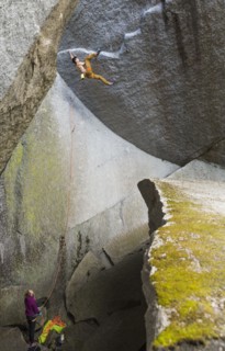 Girl watching boy rock climbing