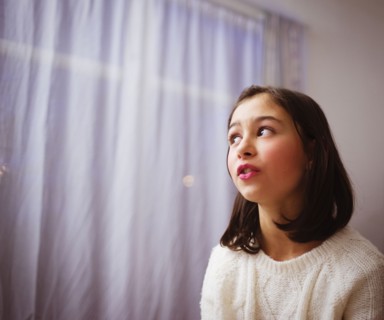Mixed race girl near window