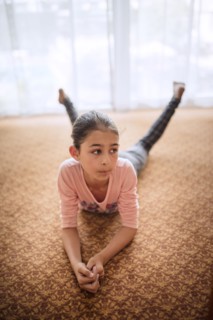 Mixed race girl laying on floor