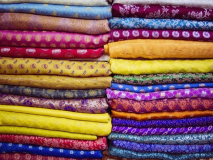 Close up of piles of multicolor fabrics
