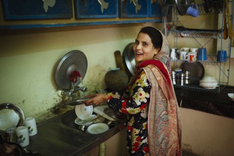Woman washing dishes in kitchen