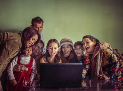 Multi-generation family videochatting on laptop