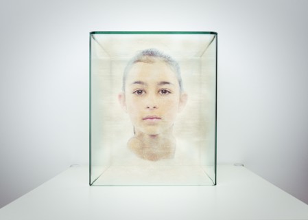 Hologram of Mixed race girl in glass box