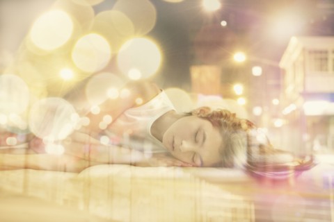 Mixed race girl dreaming of city at night