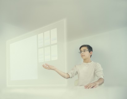 Mixed race boy using holographic screen
