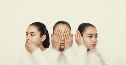 Mixed race girl covering mouth