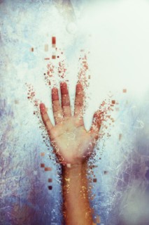 Pixelated hand dissolving