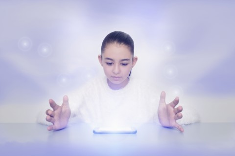 Mixed race girl with glowing digital tablet