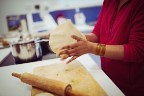 Mixed race woman cooking in kitchen