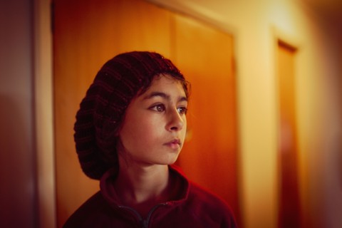Mixed race girl standing in hallway