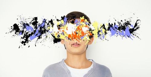 Mixed race boy with paint splatter over face